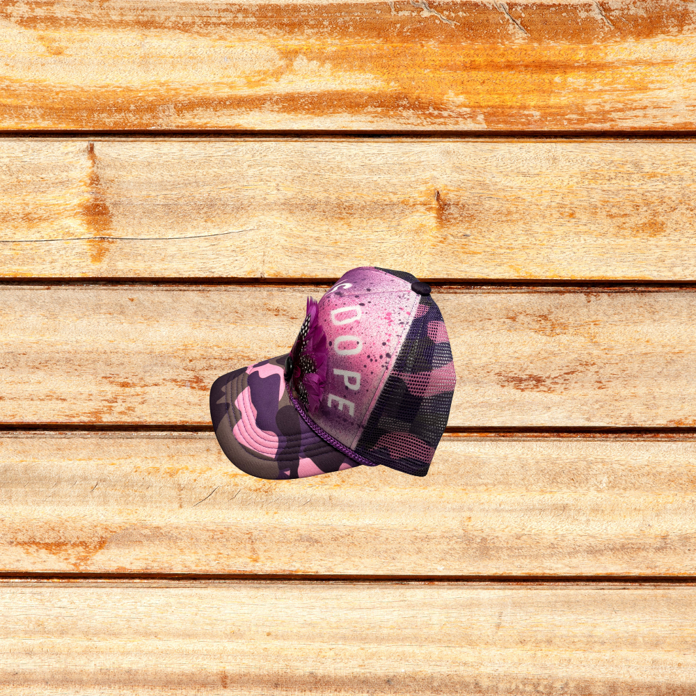 Pink and Purple Camoflouge Trucker Hat with Feathers and "God Is Dope" saying