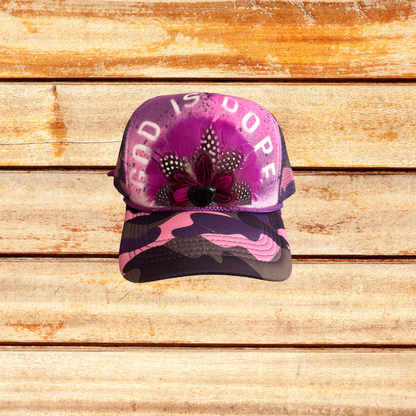 Pink and Purple Camoflouge Trucker Hat with Feathers and "God Is Dope" saying