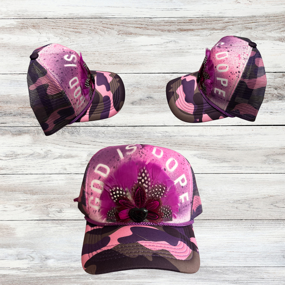 Pink and Purple Camoflouge Trucker Hat with Feathers and "God Is Dope" saying